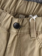 Men's Khaki elastic waist cargo pants with button closure and visible stitching detail.