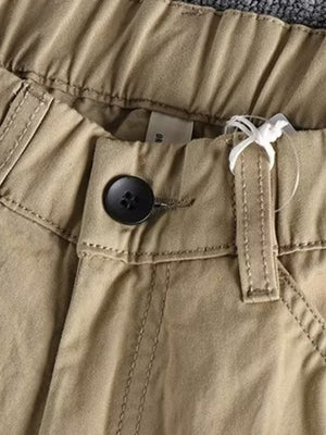 Men's Khaki elastic waist cargo pants with button closure and visible stitching detail.