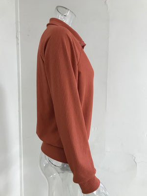 Ribbed knit plus size trench coat in orange with a collar and long sleeves.