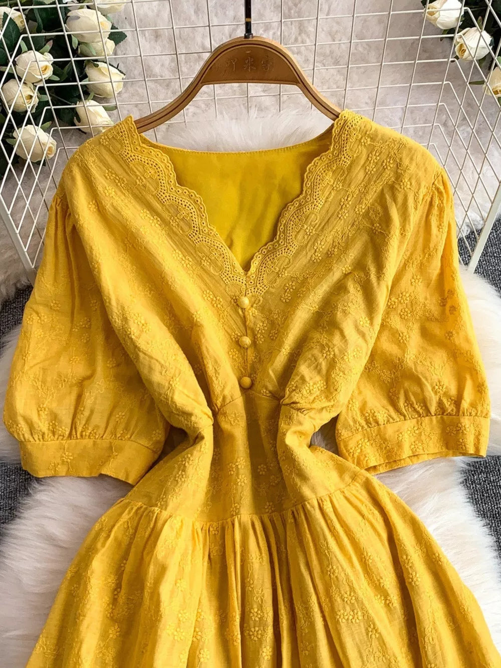 Yellow lace-embellished midi dress with V-neck and button detail
