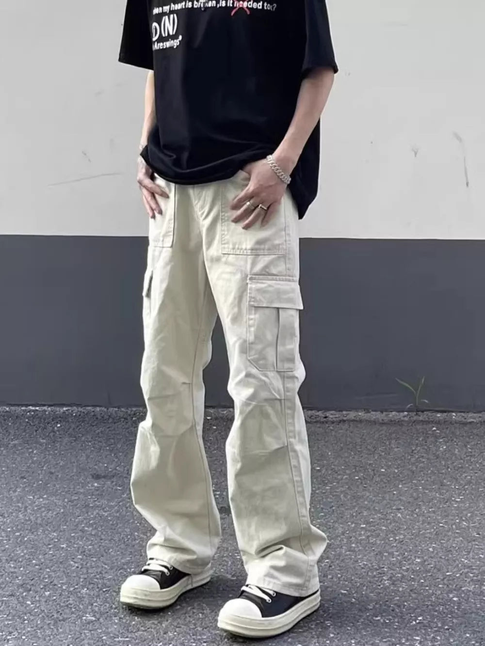 Men's relaxed fit beige cotton cargo pants with multiple pockets.