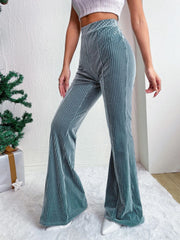 Teal corduroy bell bottom trousers with vertical ribbing.