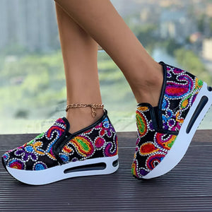 Paisley print slip-on shoes with a chunky white platform sole.