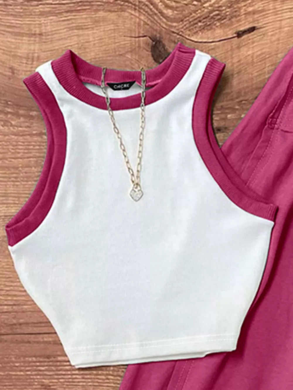 White polyester tank top with contrast trim and matching maxi skirt, styled with a necklace.
