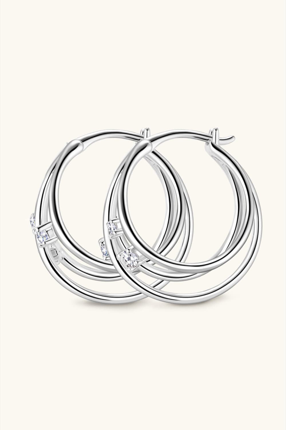 Silver hoop earrings with multiple intertwined bands and cubic zirconia accents.
