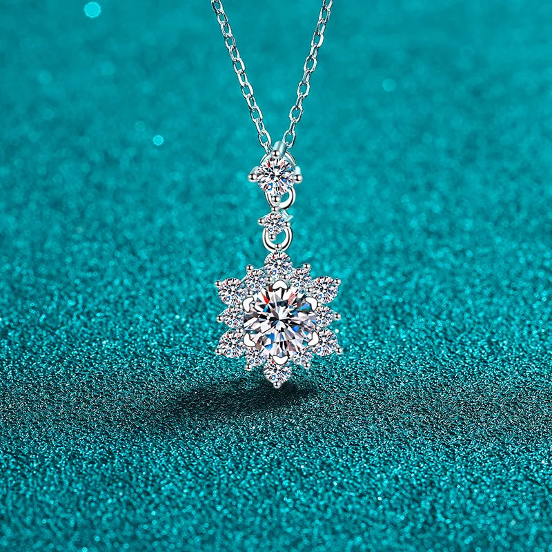 Silver moissanite pendant necklace with a floral halo design.
