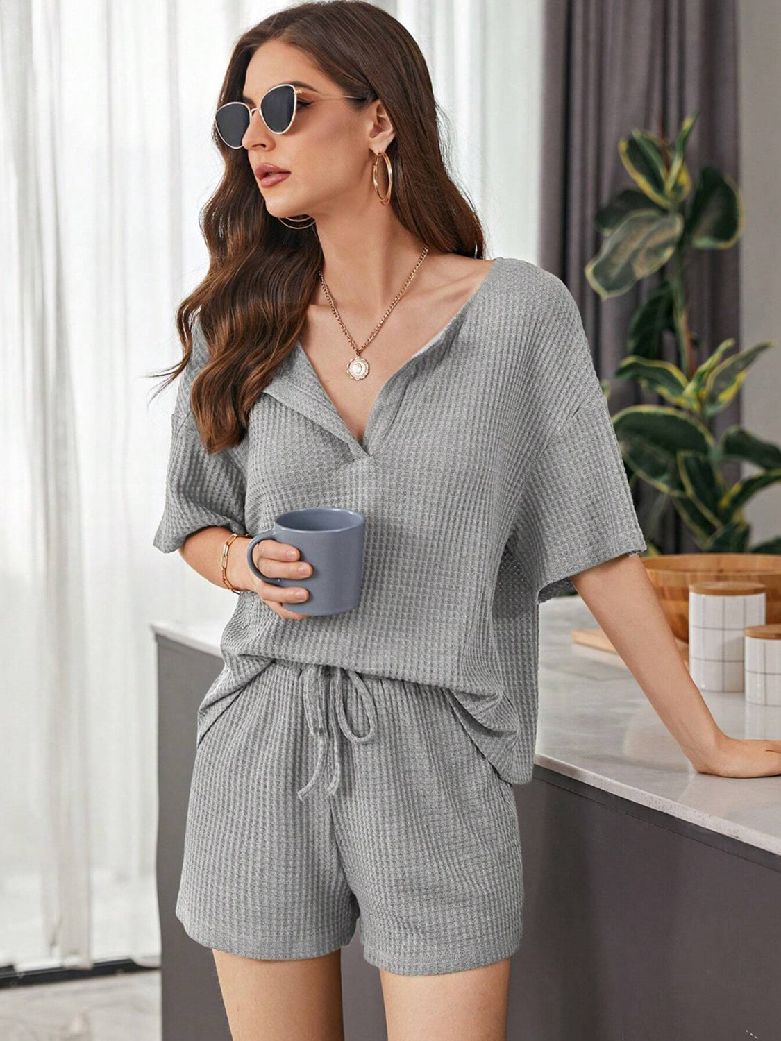 Relaxed waffle knit henley short set in dark gray with V-neck and drawstring shorts.