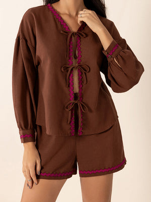 Brown linen tie-front pajama set with scallop trim and puff sleeves.