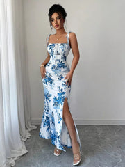 Floral print maxi dress in Peacock Blue with tie straps, ruched bodice, and thigh-high slit.