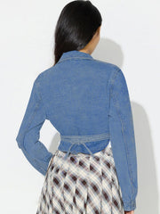 Medium wash denim wrap jacket with tie waist, long sleeves, and collar.