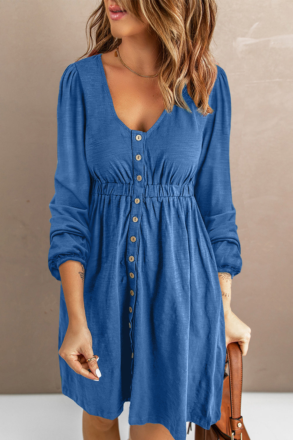 Blue button-down empire waist mini dress with V-neck and long sleeves