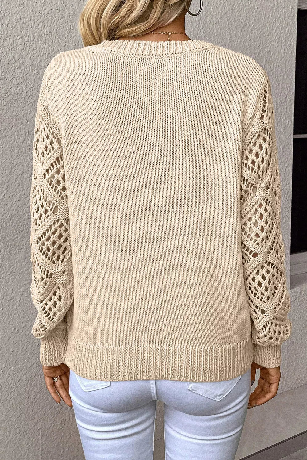 Beige knit sweater with crochet diamond sleeves and crew neck.