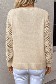 Beige knit sweater with crochet diamond sleeves and crew neck.