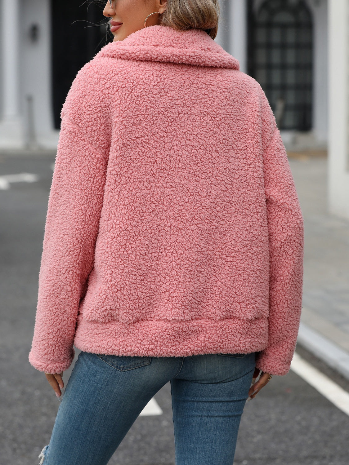 Teddy shearling zip-up jacket in burnt coral with a plush texture and collar.