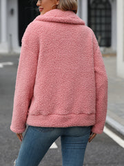 Teddy shearling zip-up jacket in burnt coral with a plush texture and collar.