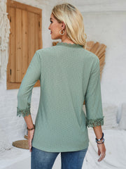 Sage green eyelet blouse with lace trim at neckline and cuffs.
