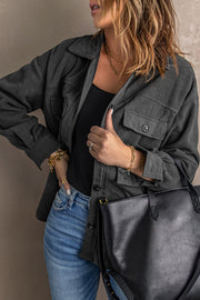 Fleece shirt jacket in Charcoal with patch pockets and button front, styled with jeans.