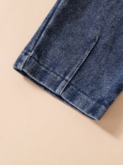Acid-wash denim jeans detail, showing stitching and hem.