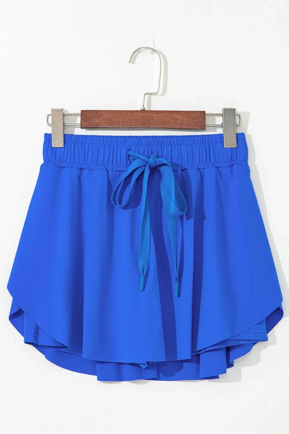 Blue flared skort with tie waist and elastic waistband.