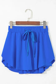 Blue flared skort with tie waist and elastic waistband.