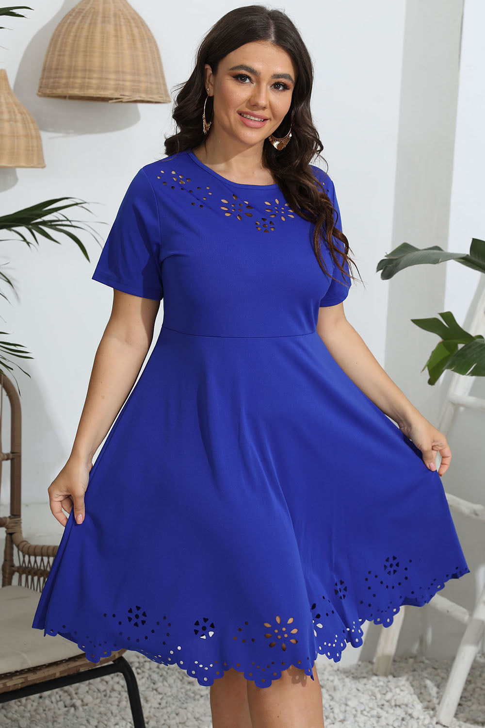Royal blue midi dress with laser cutouts on neckline and hem, short sleeves, and flared skirt.
