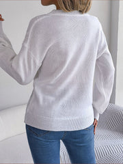 White cable knit button-front cardigan with ribbed cuffs and hem.