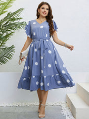 Blue polka dot midi dress with flutter sleeves and tie waist