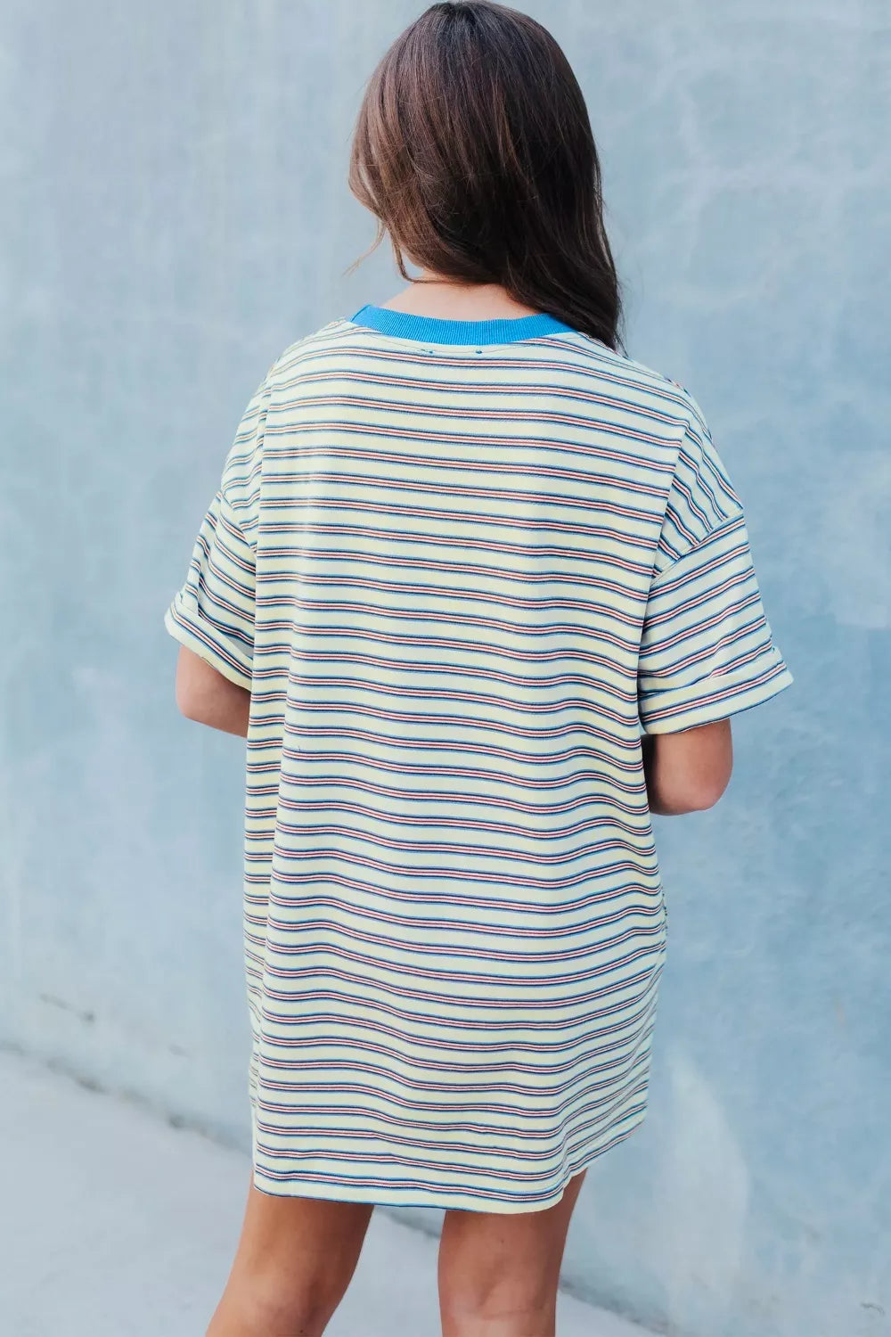 Casual striped mini dress with pockets, yellow with red and blue stripes, crew neck, short sleeves.