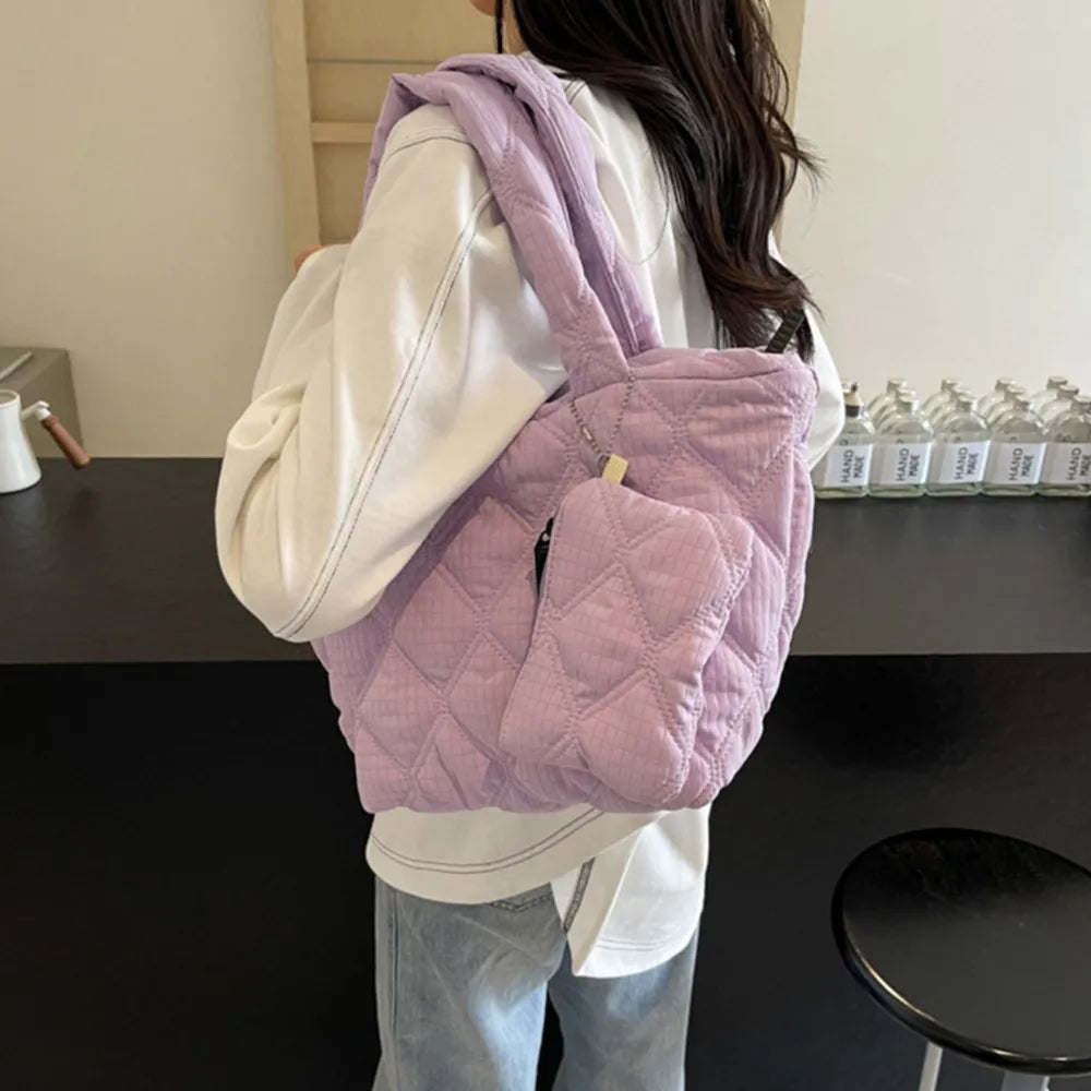 Quilted lilac tote bag with matching pouch and silver hardware.