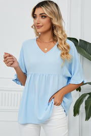 Light blue gathered yoke blouse with flutter sleeves and v-neckline.