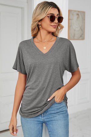 Dark Gray V-neck tee with dolman sleeves and subtle front ruching, paired with jeans.
