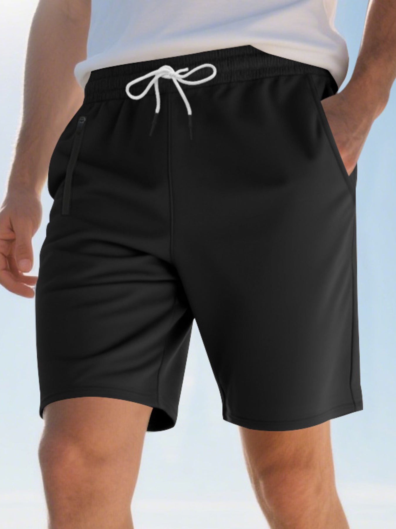 Black chino shorts with drawstring waist and zippered pocket detail.