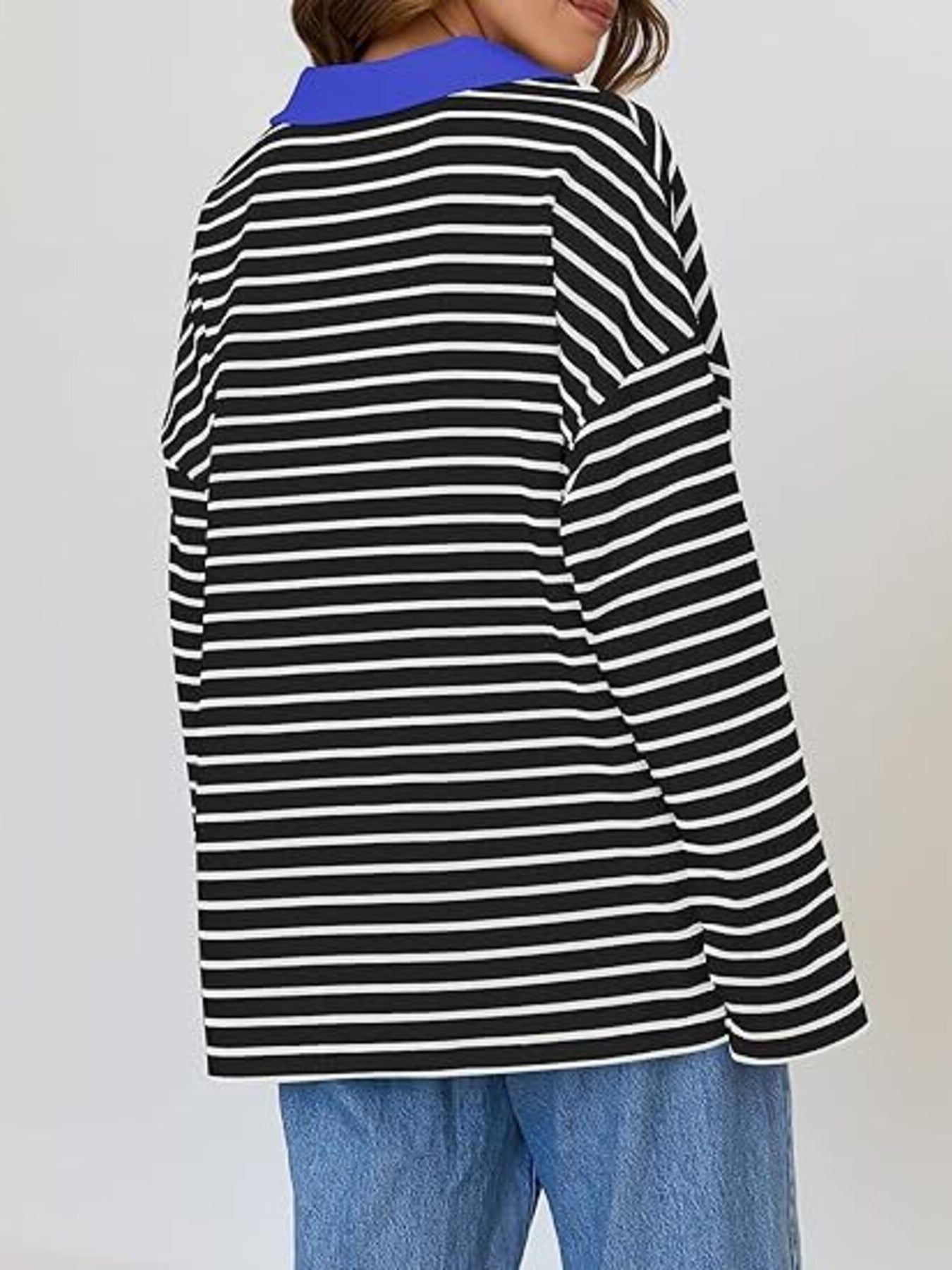 Oversized black and white striped long-sleeve sweatshirt with a blue collar.