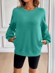 Teal relaxed fit sweatshirt with crewneck, long sleeves, and front pockets.