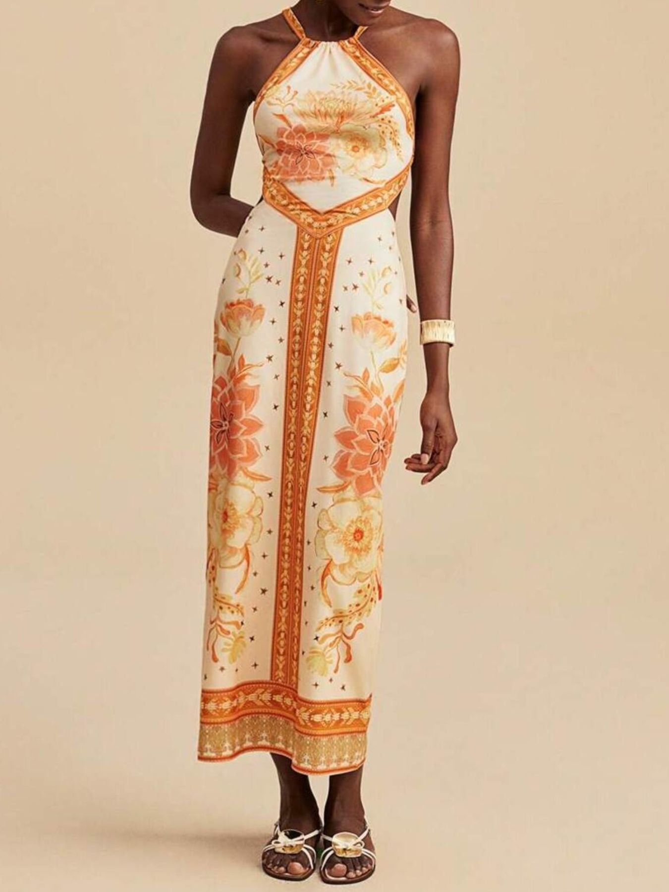 Floral print backless maxi dress with halter neck and orange floral details.
