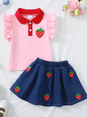 Pink polo top with strawberry embroidery and red collar, paired with a denim skirt with strawberry pattern.