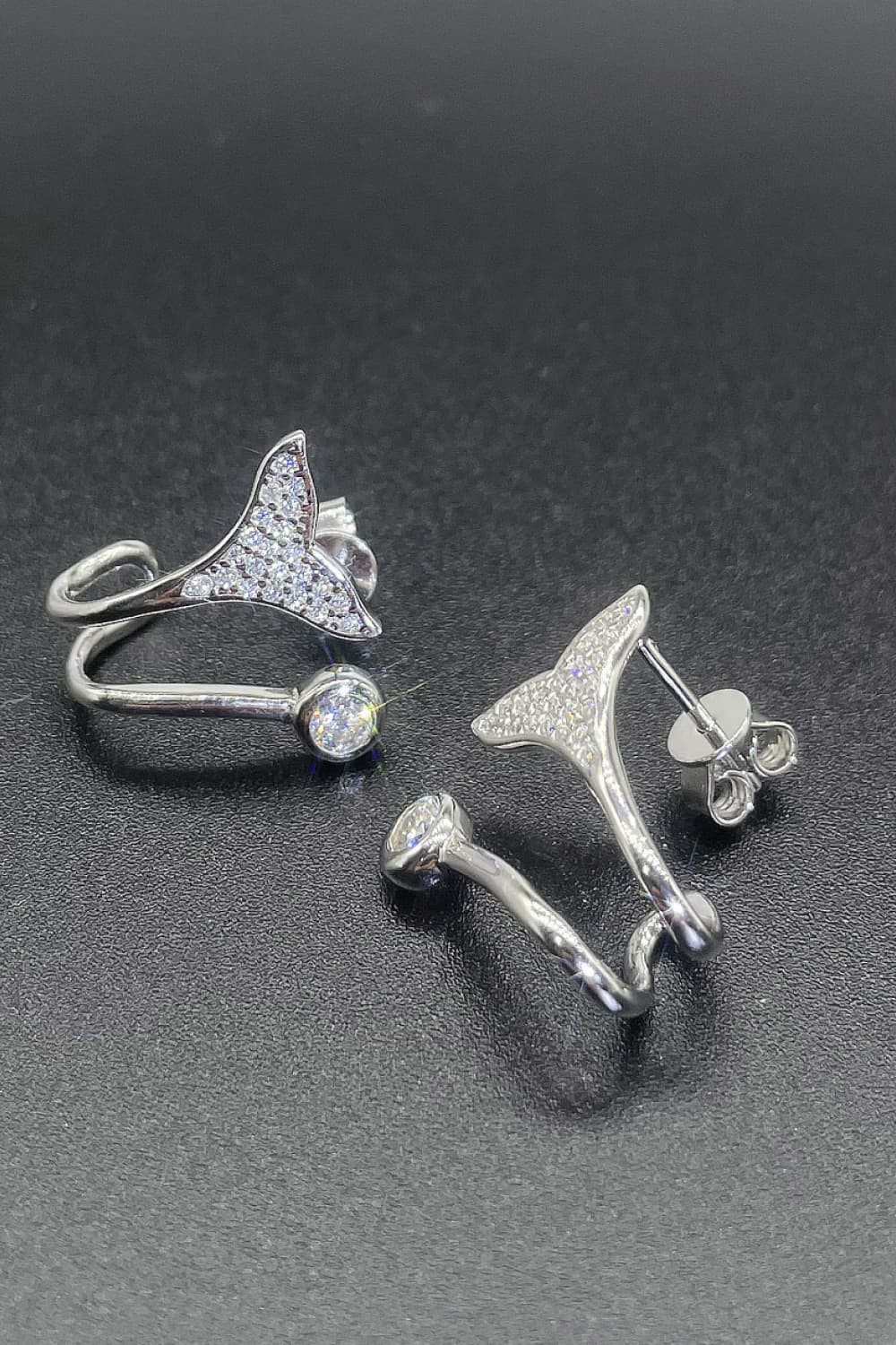 Silver crystal tail stud earrings and ring with clear cubic zirconia accents.