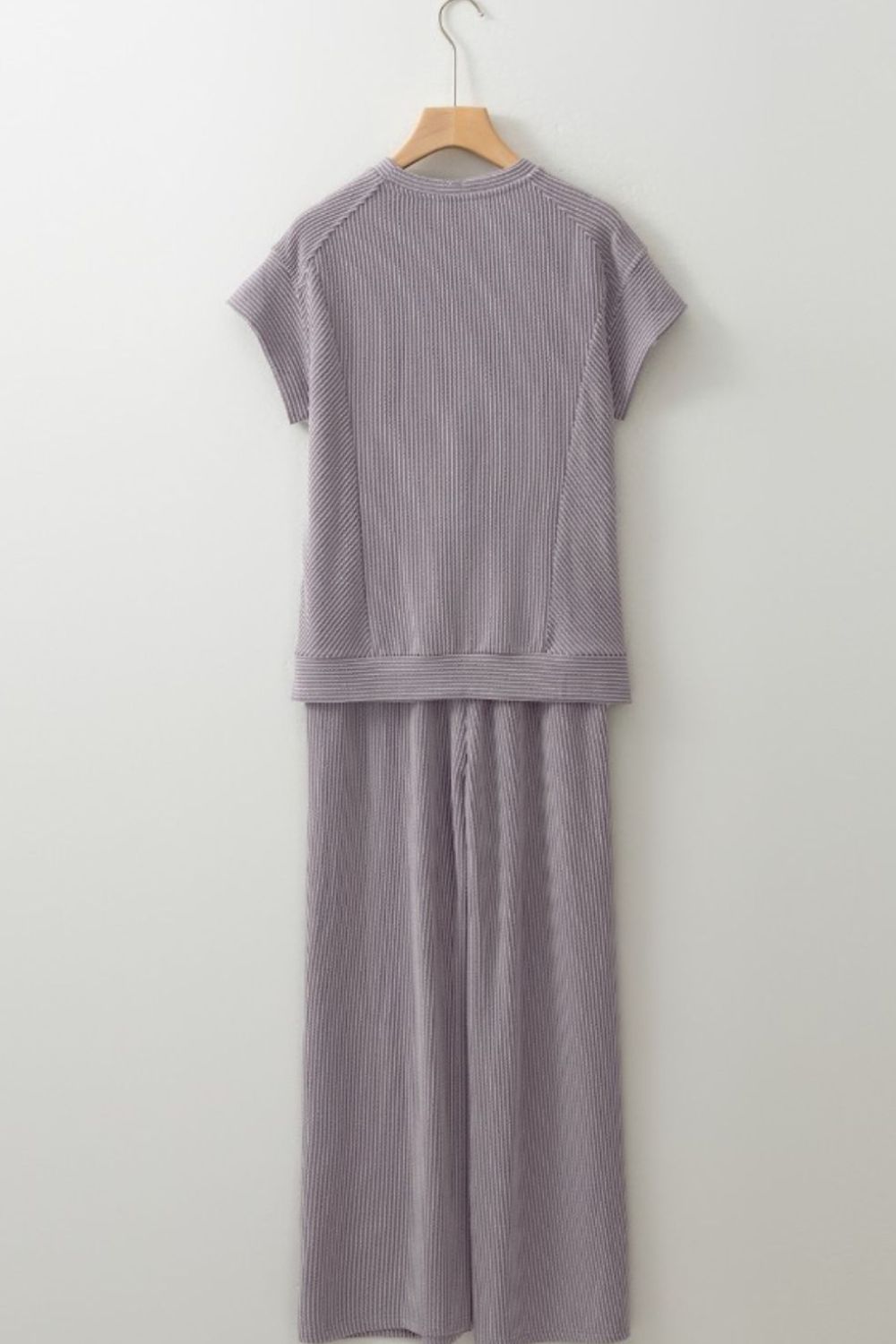 Gray ribbed knit drawstring co-ord set with short sleeves and wide leg pants.