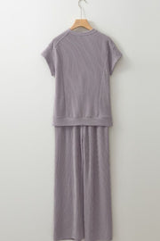 Gray ribbed knit drawstring co-ord set with short sleeves and wide leg pants.