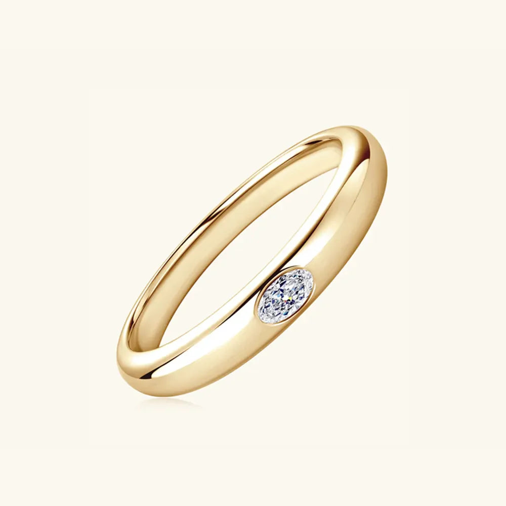 Gold band ring with oval moissanite accent