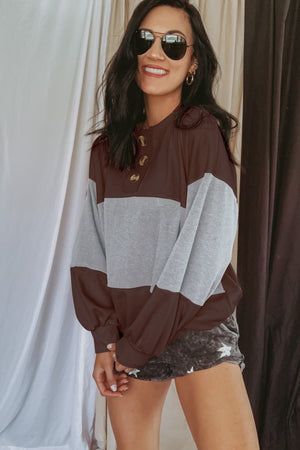 Colorblock henley sweatshirt with balloon sleeves in gray and brown, featuring a button neckline.