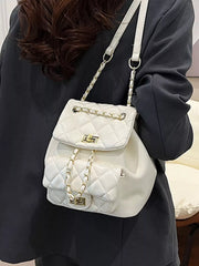 White quilted mini backpack with gold chain straps and front flap pocket.