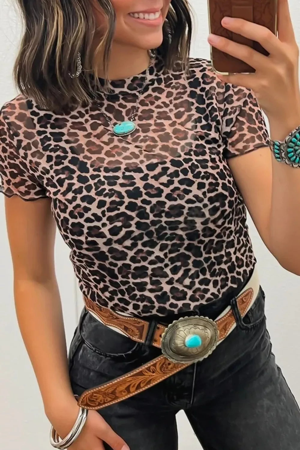 Leopard print sheer mesh t-shirt with short sleeves and mock neck.