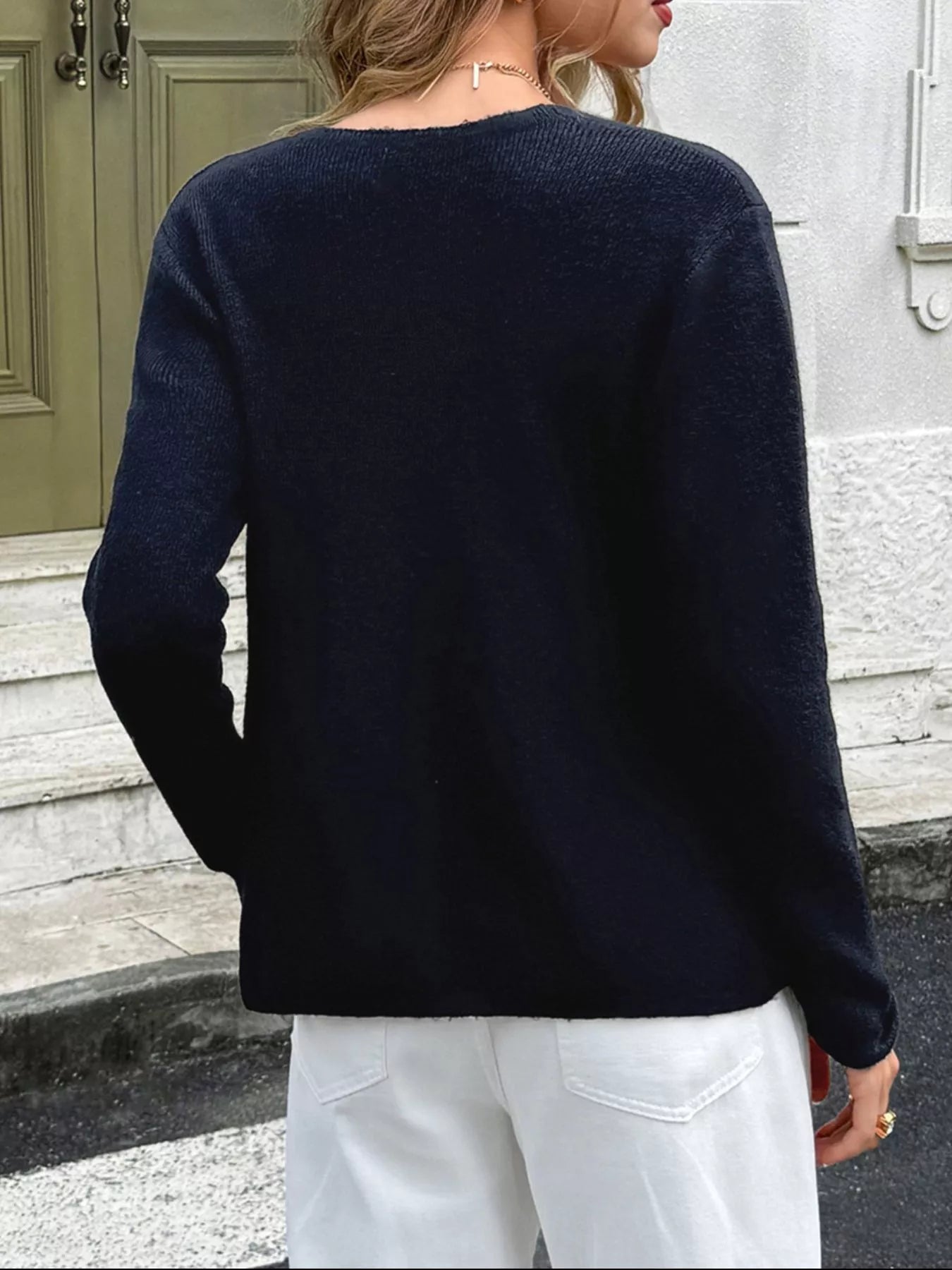 Navy double-breasted knit cardigan with a relaxed fit and long sleeves.
