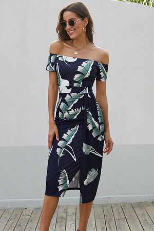 Navy off-shoulder midi dress with white and green leaf print and a side slit.