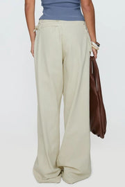 Cream cotton denim trousers with flared leg and utility buckle detail
