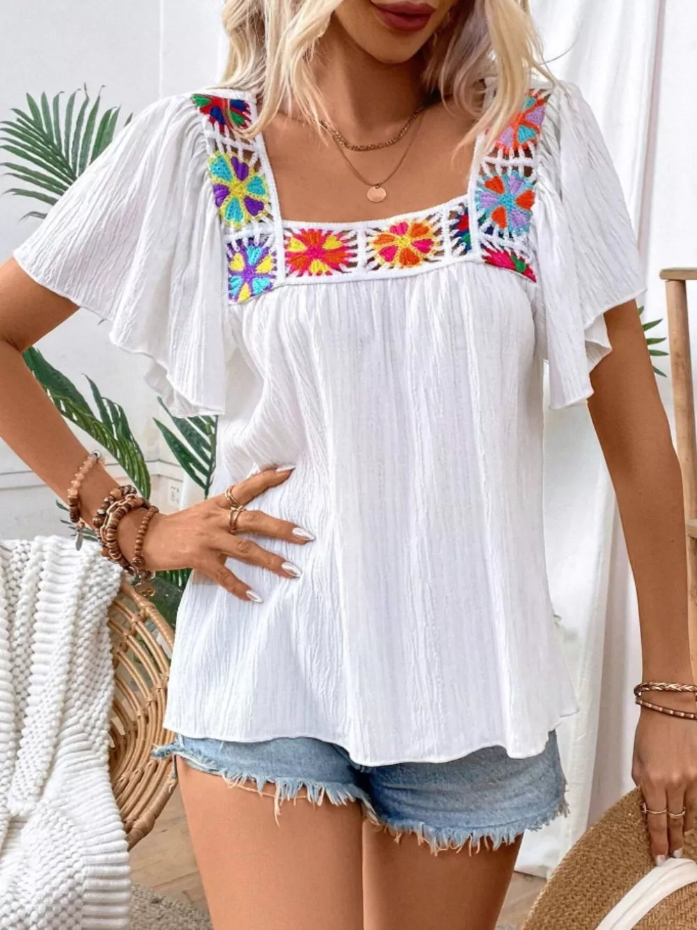 White embroidered square neck flutter sleeve blouse with colorful floral detail