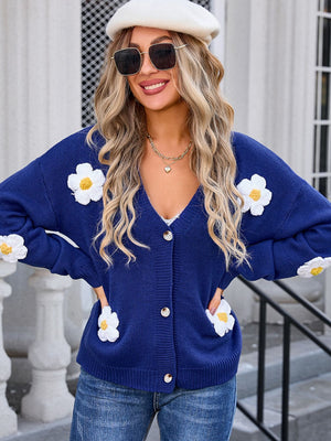 Navy acrylic V-neck cardigan with white daisy appliqués and button front.
