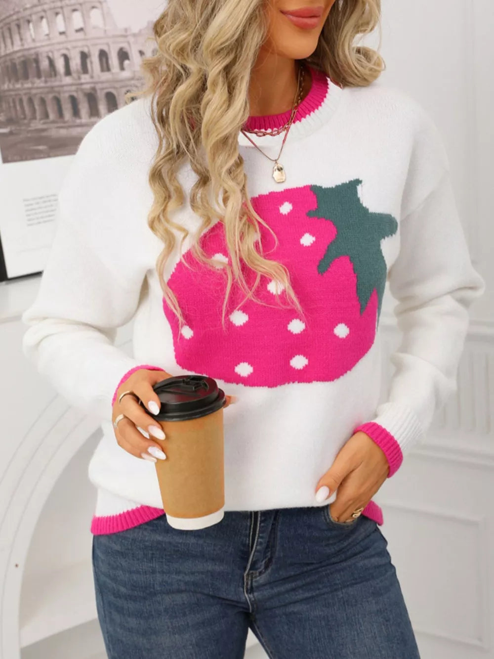 White acrylic blend sweater with a large pink strawberry graphic and pink trim.