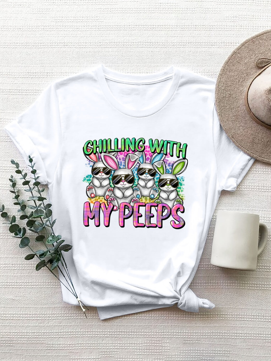 White graphic t-shirt with cartoon bunnies wearing sunglasses and the text My Peeps